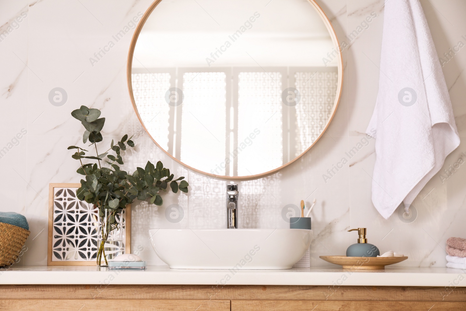 Photo of Stylish bathroom interior with vessel sink and round mirror