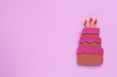 Birthday party. Paper cake with candles on pink background, top view. Space for text