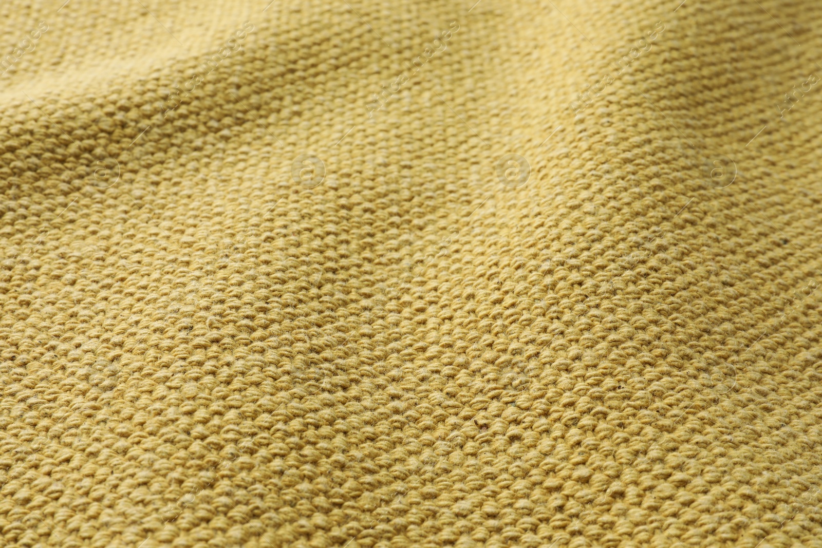 Photo of Texture of golden color fabric as background, closeup