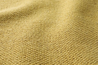 Texture of golden color fabric as background, closeup