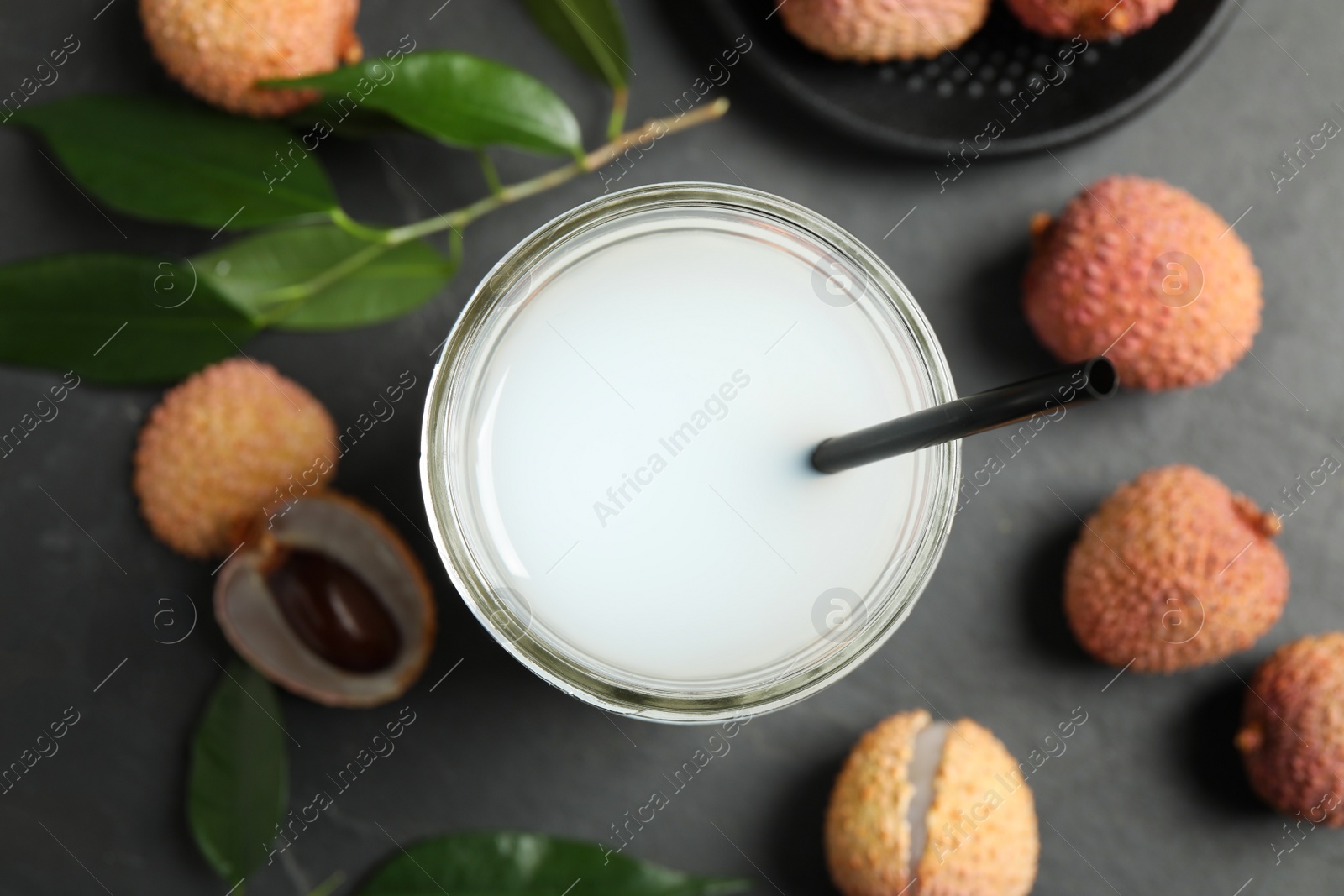 Photo of Fresh lychee juice and fruits on grey table, flat lay