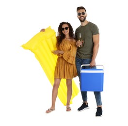 Happy couple with cool box, inflatable mattress and bottle of beer on white background