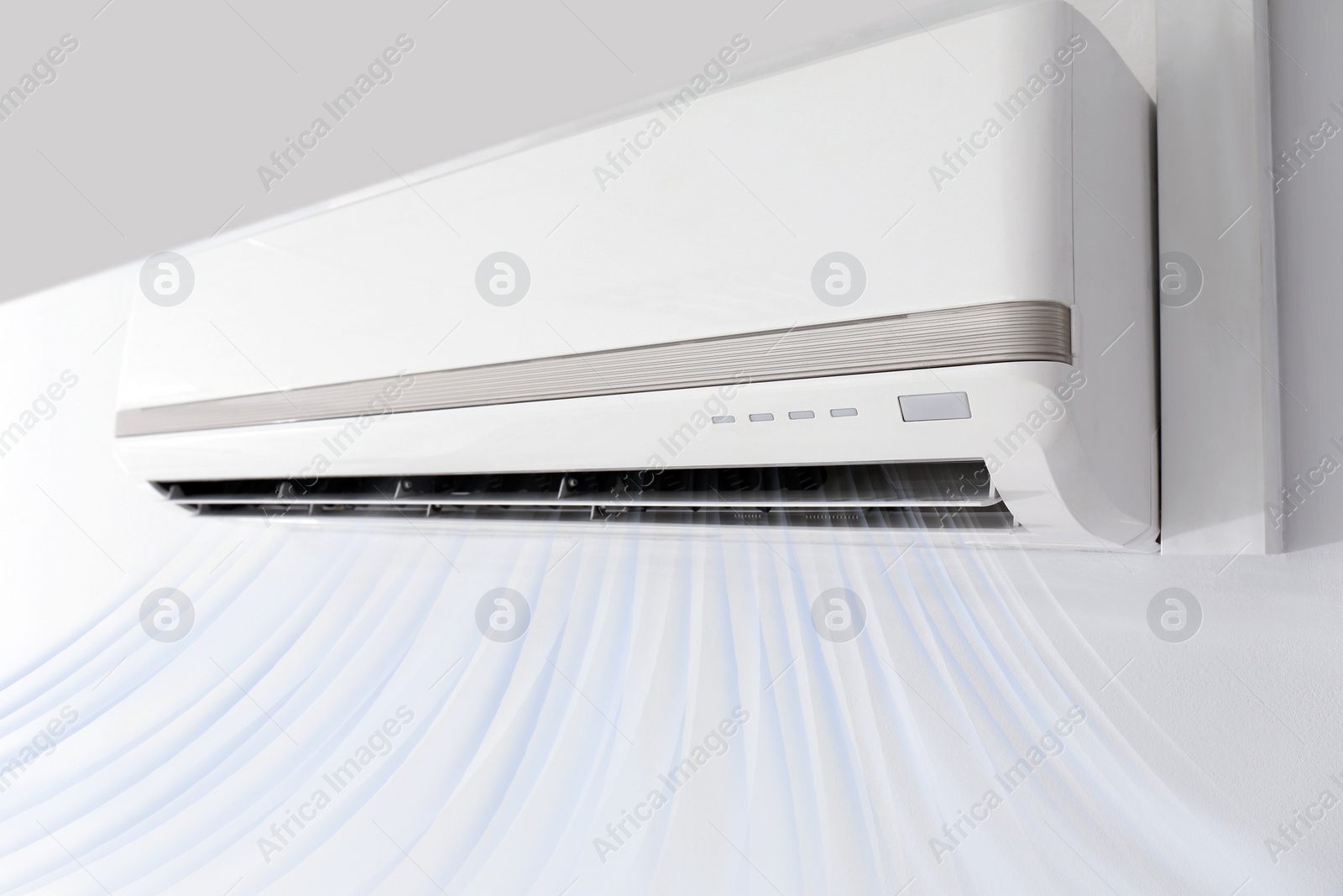 Image of Modern air conditioner on white wall indoors