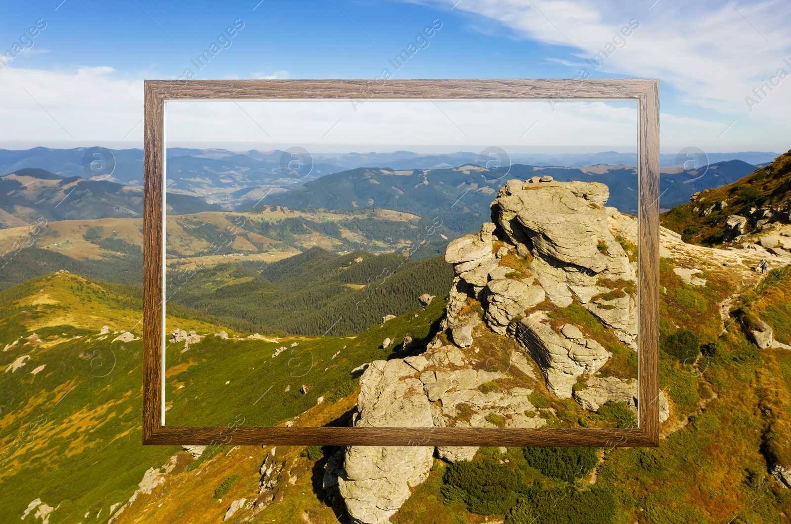 Image of Wooden frame and beautiful mountains under blue sky with clouds