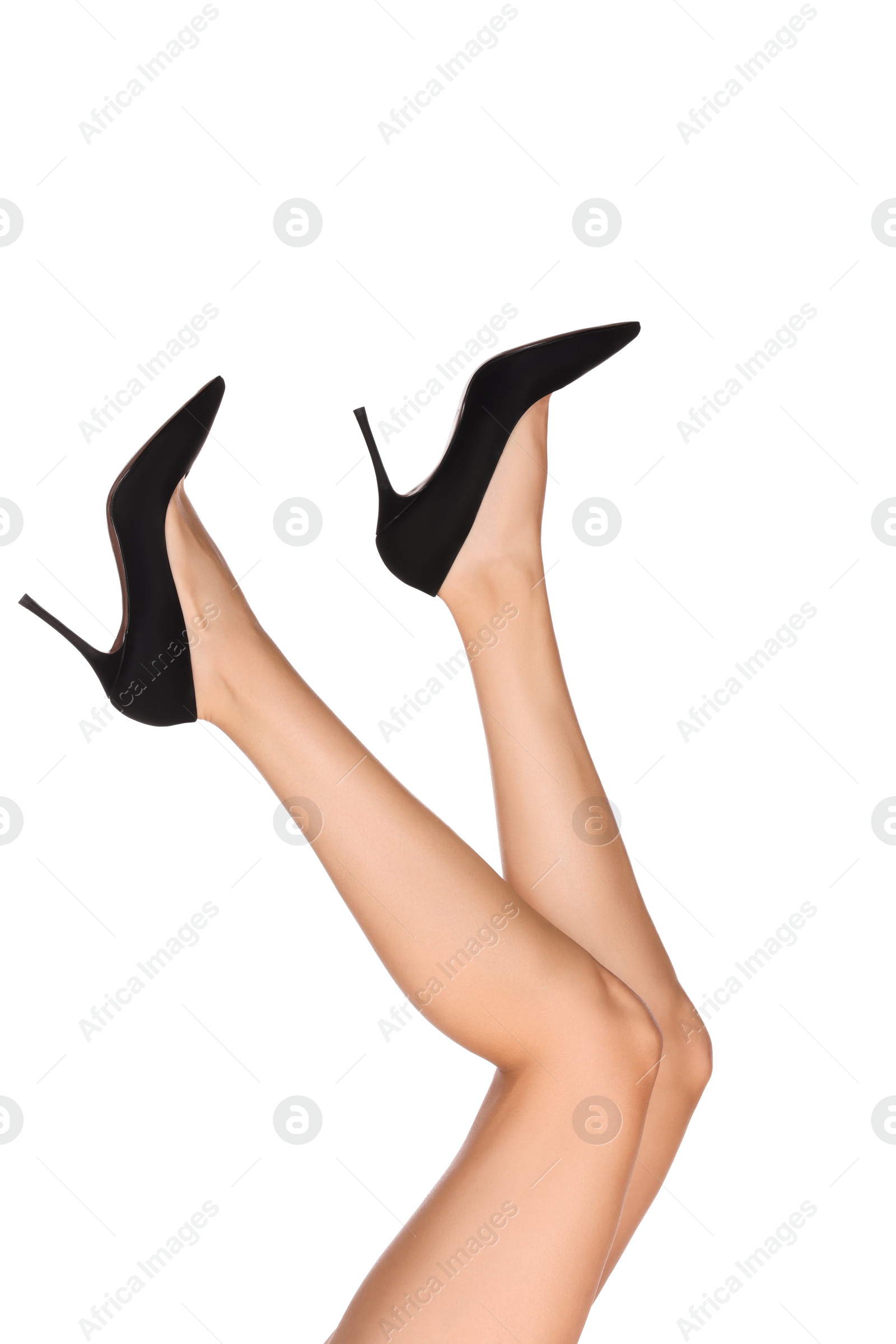 Photo of Woman with beautiful long legs wearing black shoes on white background, closeup