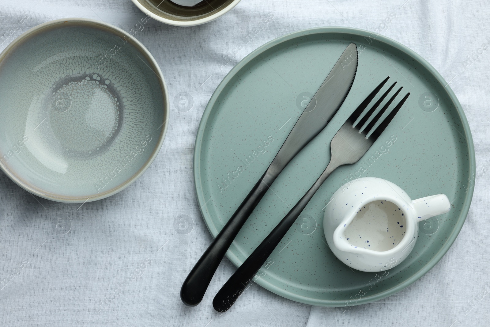 Photo of Stylish empty dishware and cutlery on table, flat lay