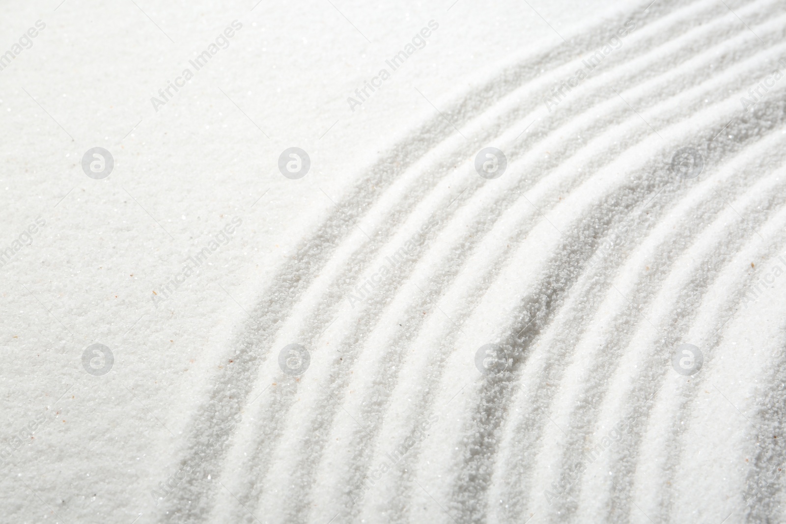 Photo of Zen rock garden. Wave pattern on white sand