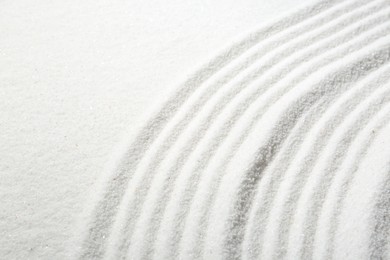 Zen rock garden. Wave pattern on white sand