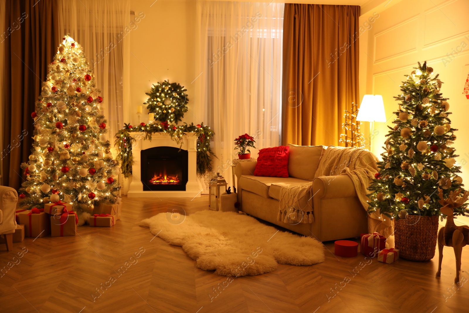 Photo of Festive living room interior with Christmas trees and fireplace