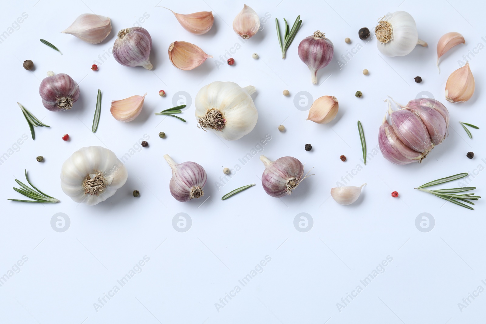 Photo of Fresh garlic, rosemary and peppercorns on white background, flat lay. Space for text