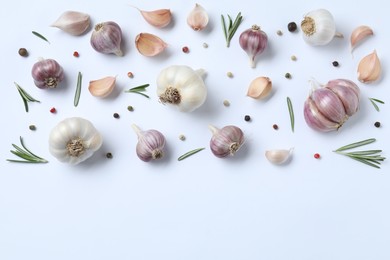 Photo of Fresh garlic, rosemary and peppercorns on white background, flat lay. Space for text