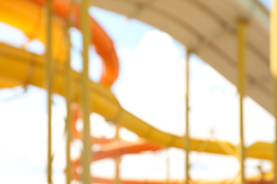 Photo of Different colorful slides in water park, blurred view