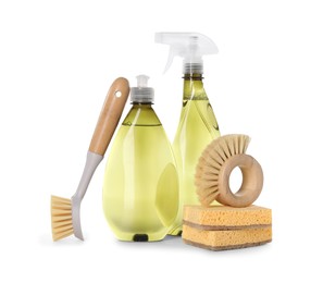 Bottles of cleaning product, brushes and sponges isolated on white