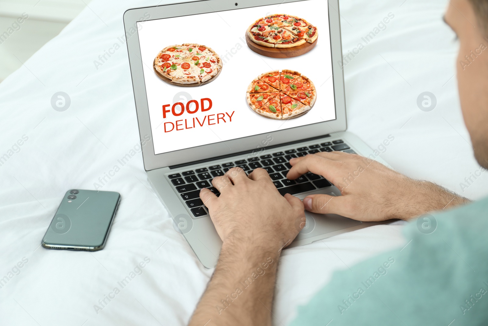 Image of Man using laptop for online food order during quarantine, closeup. Delivery service