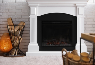 Photo of Firewood near modern fireplace in living room