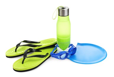 Photo of Swimming cap, goggles, water bottle and flip flops isolated on white