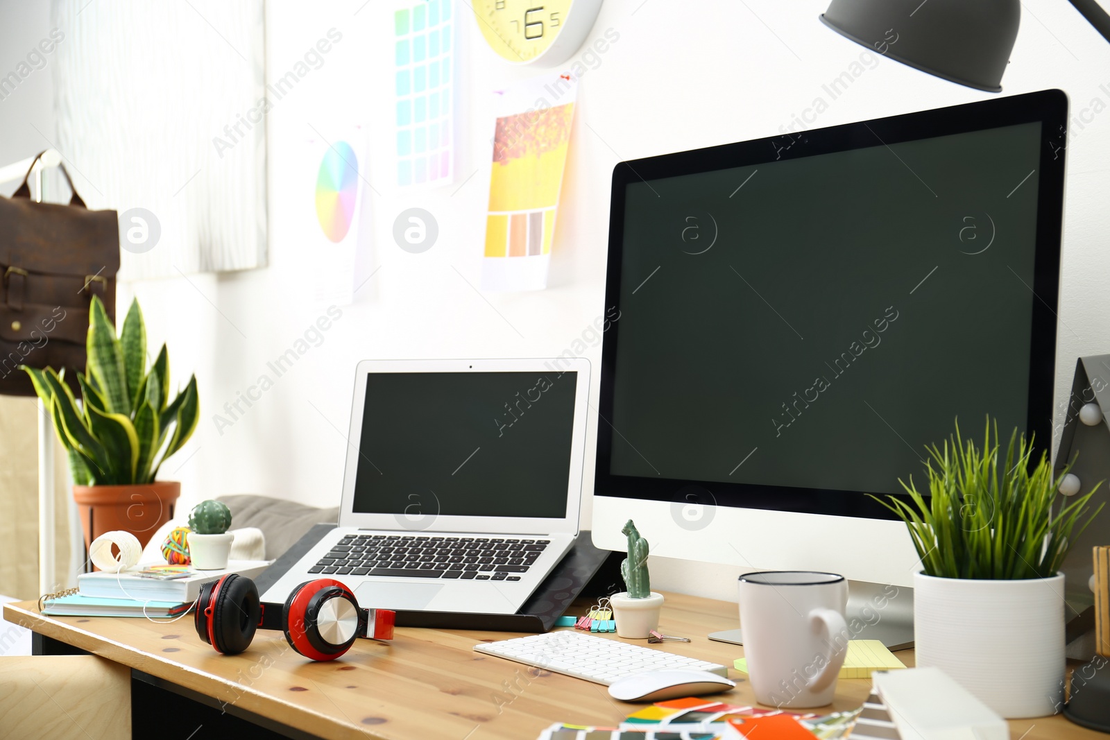 Photo of Modern laptop, computer and office supplies on wooden table, space for text. Designer's workplace