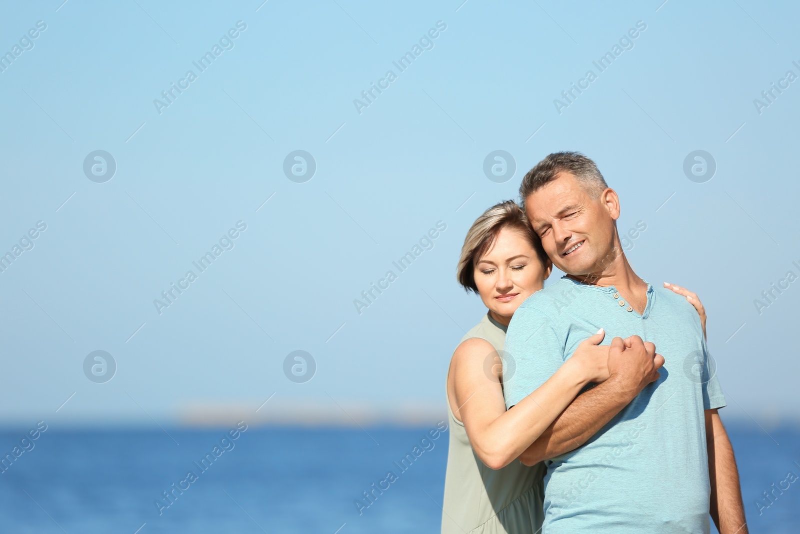 Photo of Happy mature couple at beach on sunny day