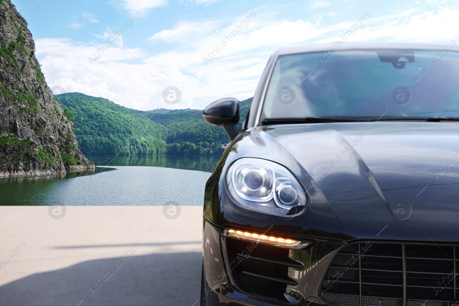 Image of Modern car on asphalt road in mountains