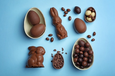 Photo of Flat lay composition with chocolate Easter eggs on color background