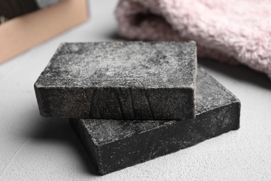 Photo of Natural tar soap on white table, closeup