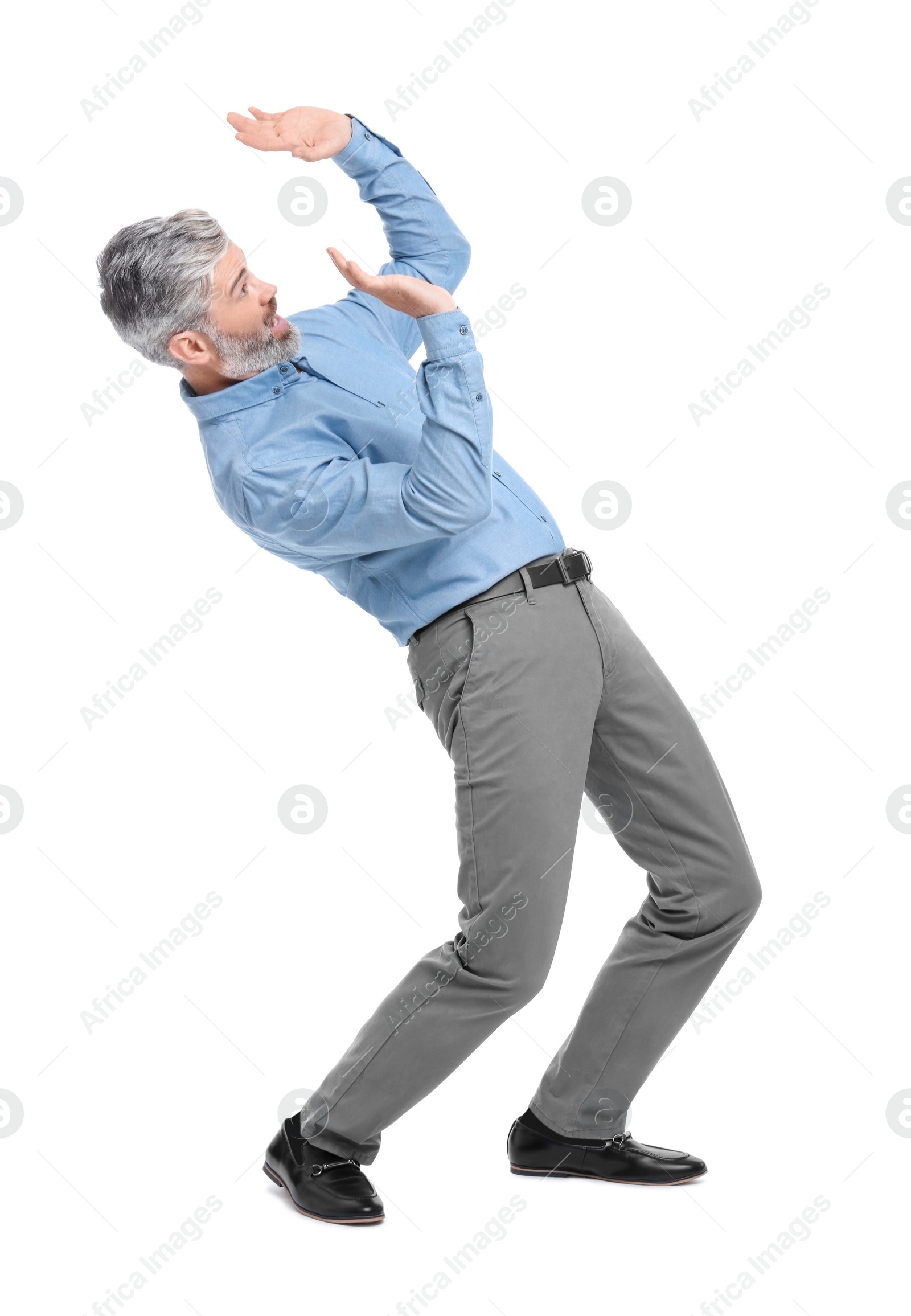 Photo of Mature businessman in stylish clothes avoiding something on white background