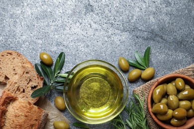 Photo of Flat lay composition with olive oil on grey table, flat lay. Space for text