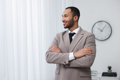 Photo of Portrait of smiling young man in office, space for text. Lawyer, businessman, accountant or manager