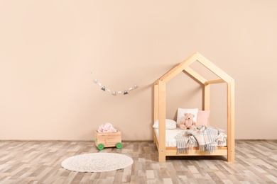 Stylish child room interior with house bed. Space for text