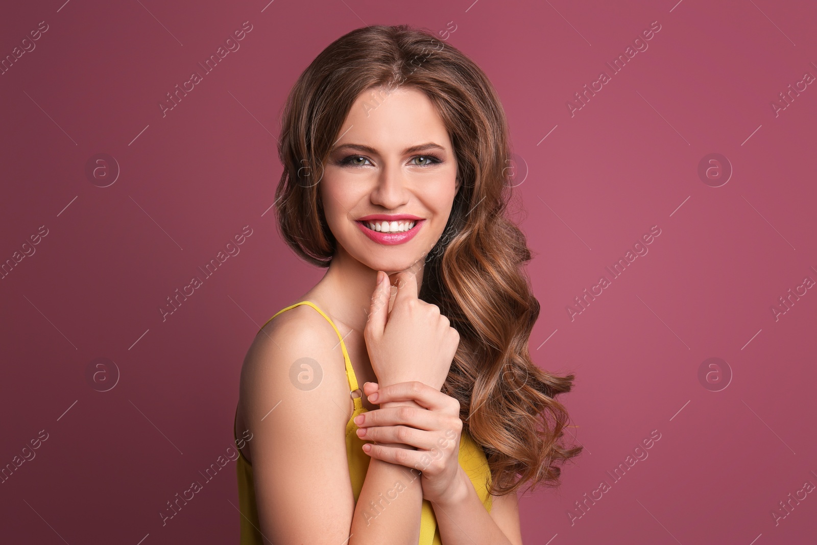 Photo of Portrait of young woman with long beautiful hair on color background