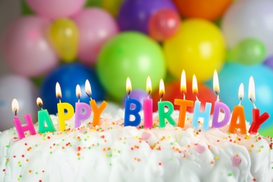 Photo of Birthday cake with burning candles on blurred background, closeup