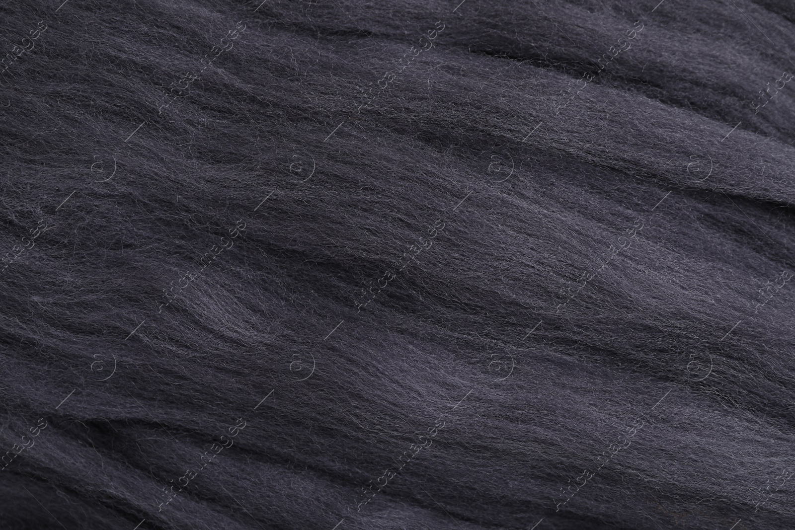 Photo of Grey felting wool as background, closeup view