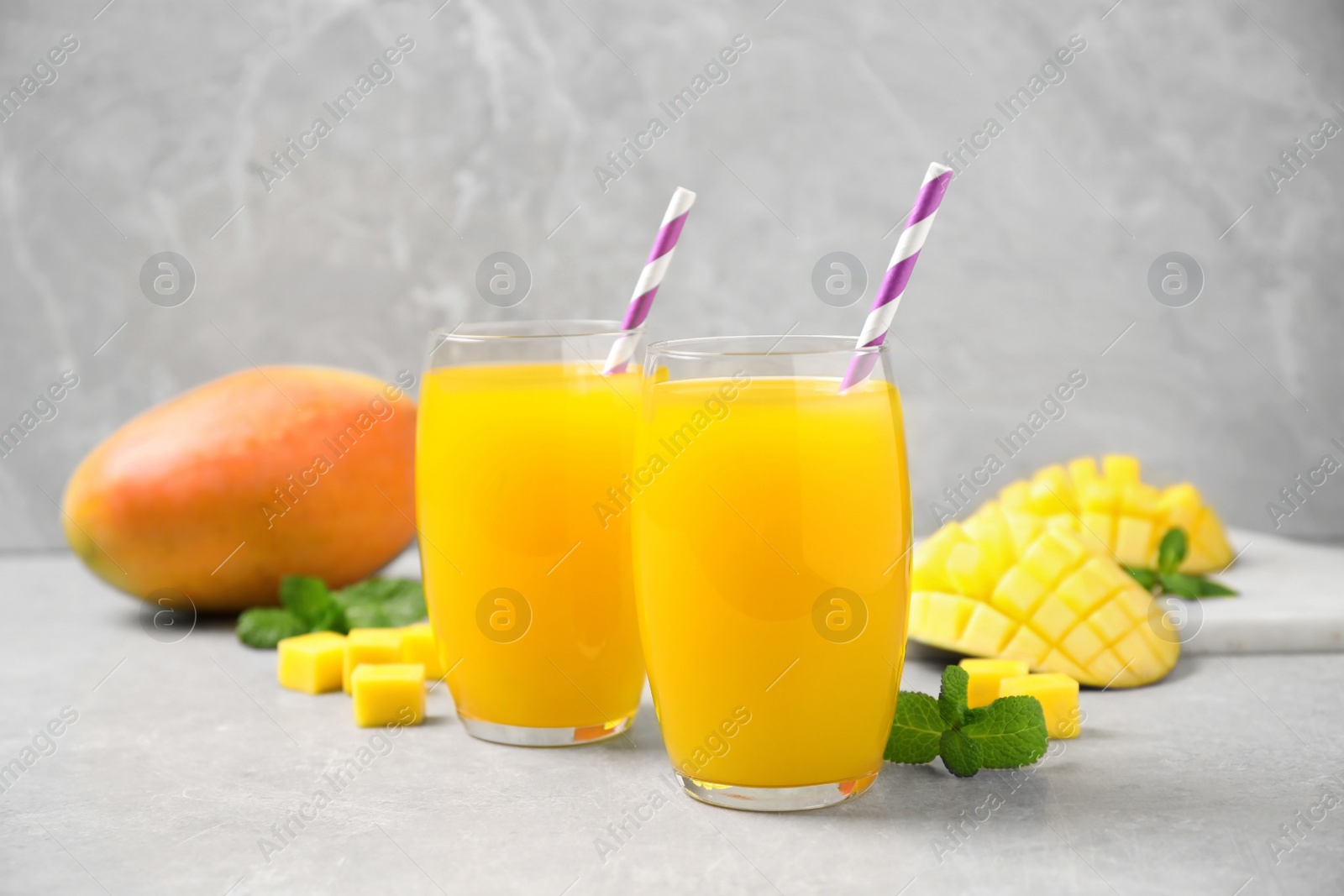 Photo of Fresh delicious mango drink on light table