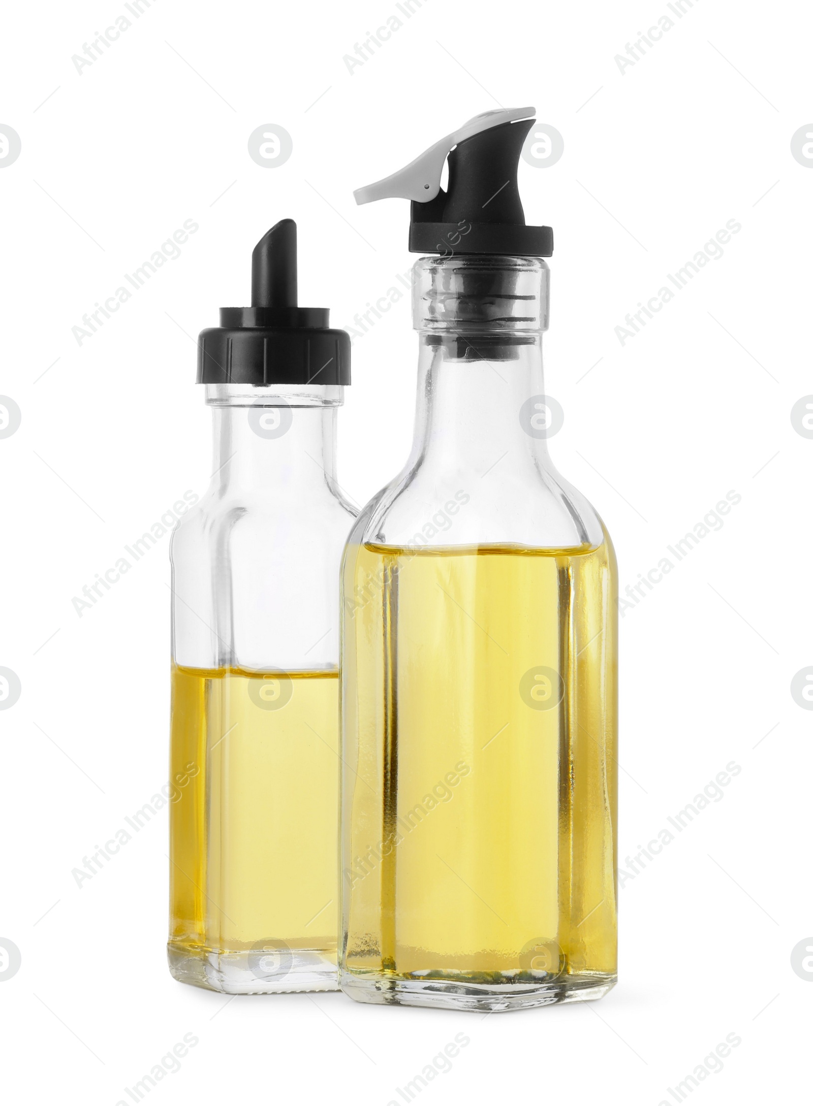 Photo of Different glass bottles of cooking oil on white background