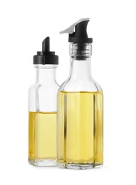 Photo of Different glass bottles of cooking oil on white background