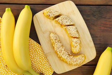 Photo of Delicious fresh and fried bananas on wooden table, flat lay