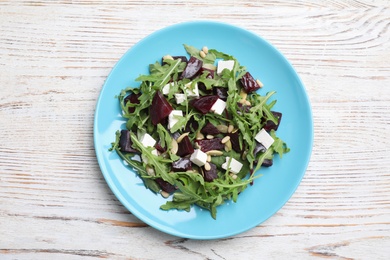 Photo of Fresh delicious beet salad on white wooden table, top view