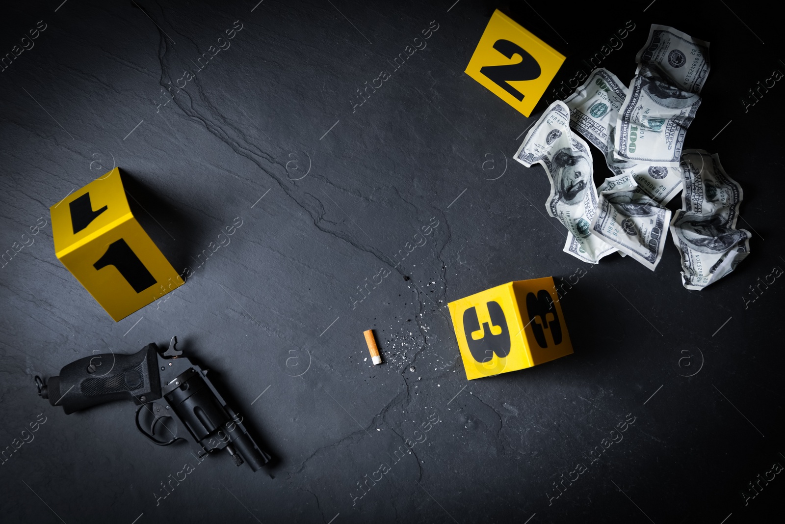 Photo of Flat lay composition with evidences and crime scene markers on black background