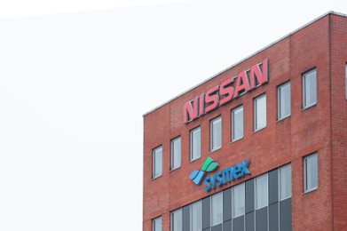 Photo of Warsaw, Poland - September 10, 2022: Building with modern Nissan and Sysmex logos