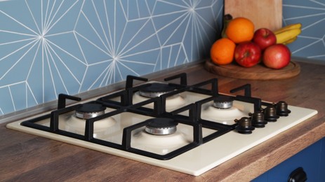 Photo of Modern gas cooktop in kitchen. Cooking appliance