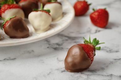 Photo of Delicious chocolate covered strawberry on table, closeup