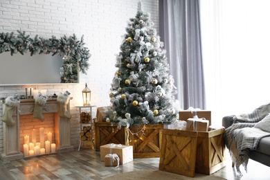 Stylish interior with decorated Christmas tree in living room