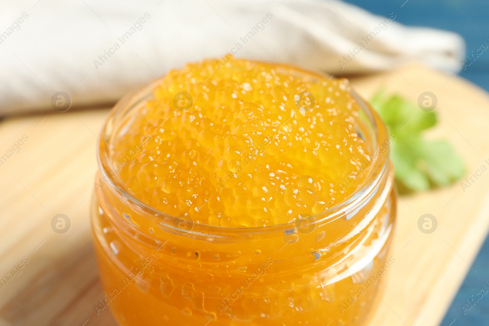 Photo of Fresh pike caviar in glass jar on table, closeup