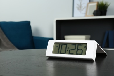 Photo of Digital clock on table indoors, space for text. Time management