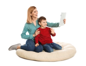Mother and her son using video chat on tablet, white background
