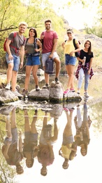 Group of friends hiking outdoors. Camping vacation