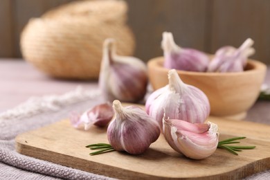 Photo of Bulbs and cloves of fresh garlic on table, closeup. Space for text