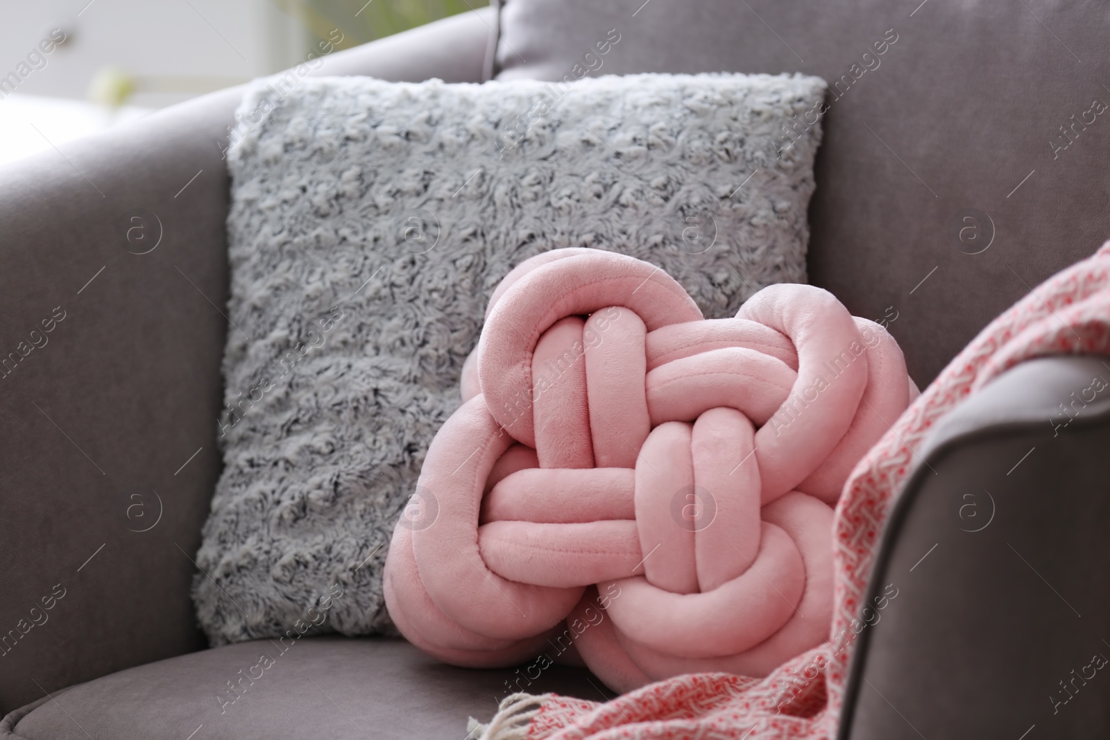 Photo of Pillows and plaid on armchair. Idea for interior design