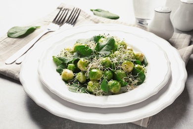 Plate of delicious salad with Brussels sprouts on table