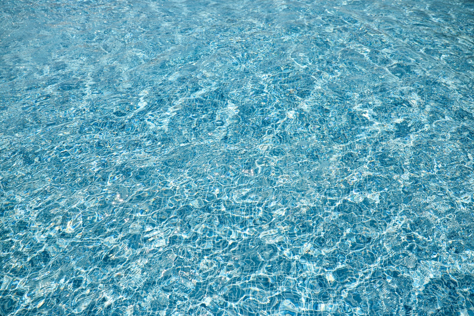 Photo of Swimming pool with clean blue water as background. Summer vacation